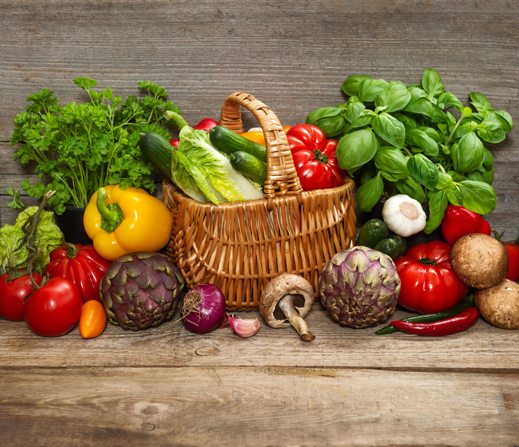 vegetables and herbs on wooden background